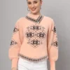 Peach women’s short-length winter sweater top with black ethnic pattern, asymmetric buttoned neckline, and full sleeves