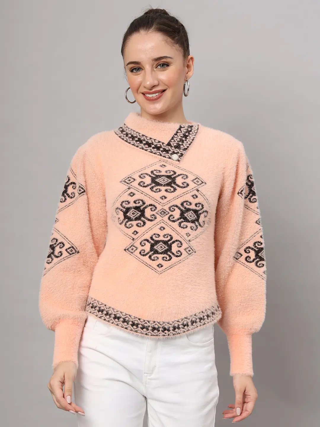 Peach women’s short-length winter sweater top with black ethnic pattern, asymmetric buttoned neckline, and full sleeves