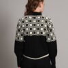 Women's black and ivory geometric Nordic cable knit short-length winter sweater top with ribbed high neck, buttons, and balloon sleeves
