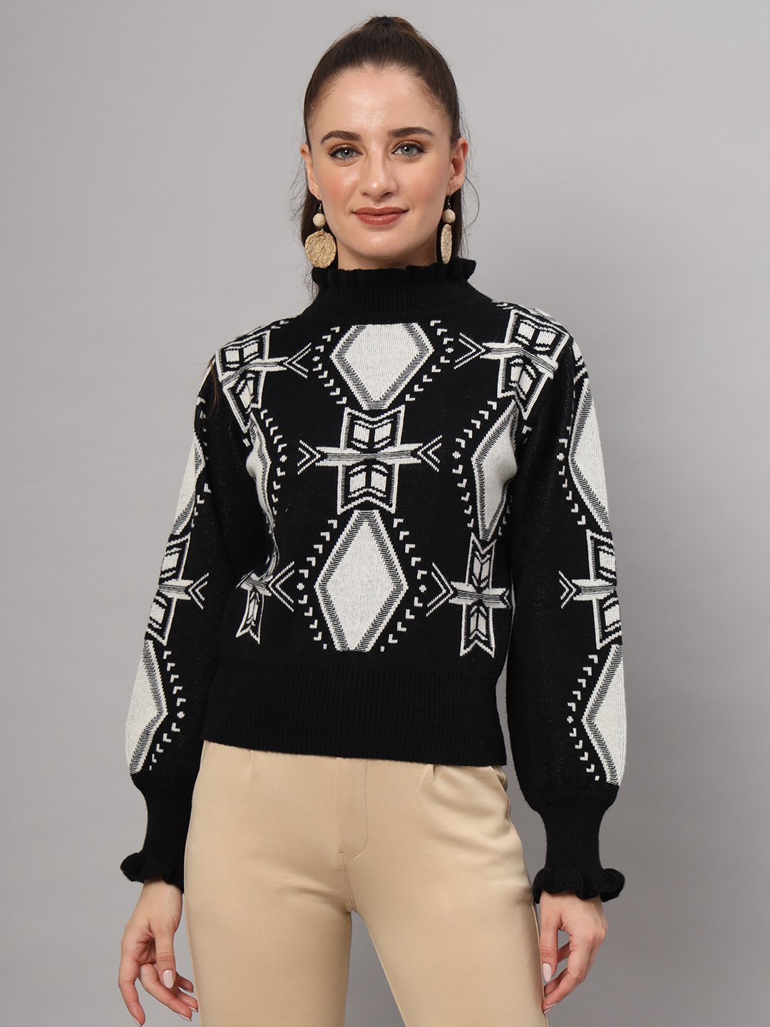 Elevate your winter fashion with this women’s black and white geometric ruffled high-neck mid-length sweater top. Featuring bold patterns, delicate ruffle accents, and plush knit warmth, this chic silhouette pairs effortlessly with pants or skirts for a standout seasonal ensemble. Perfect for adding a touch of modern elegance to your cold-weather collection.