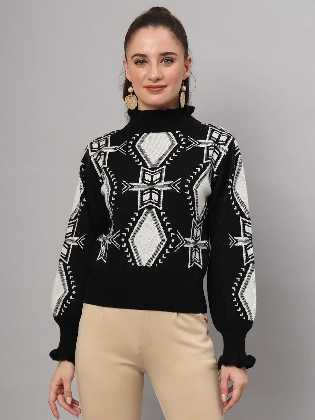 Elevate your winter fashion with this women’s black and white geometric ruffled high-neck mid-length sweater top. Featuring bold patterns, delicate ruffle accents, and plush knit warmth, this chic silhouette pairs effortlessly with pants or skirts for a standout seasonal ensemble. Perfect for adding a touch of modern elegance to your cold-weather collection.