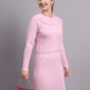 Woman wearing light pink ribbed knit winter dress with scallop hem and peter pan collar, styled with ankle boots.