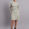 Woman wearing pistachio green ribbed knit winter dress with scallop hem and peter pan collar, paired with ankle boots Woman wearing pistachio green ribbed knit winter dress with scallop hem and peter pan collar, paired with ankle boots