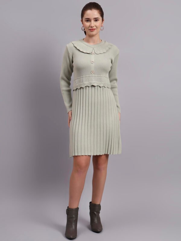 Woman wearing pistachio green ribbed knit winter dress with scallop hem and peter pan collar, paired with ankle boots Woman wearing pistachio green ribbed knit winter dress with scallop hem and peter pan collar, paired with ankle boots