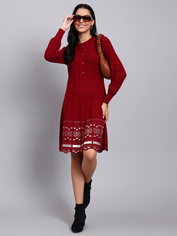 Woman in maroon knit winter dress with pink and white patterned hem, button front, and long sleeves