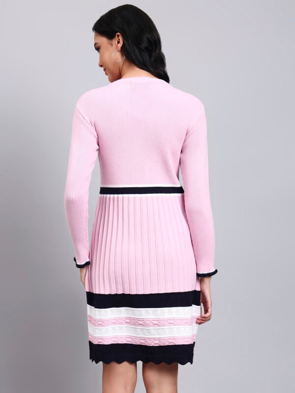 Woman in pink ribbed knit winter dress with navy and white scalloped collar, border stripes, and long sleeves