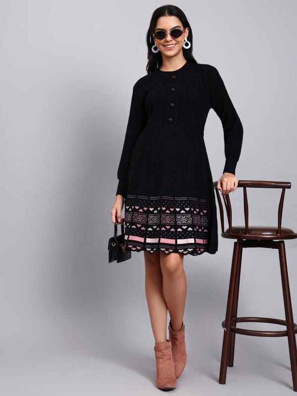 Woman in black knit winter dress with pink and white patterned hem, button front, and long sleeves Woman in black knit winter dress with pink and white patterned hem, button front, and long sleeves
