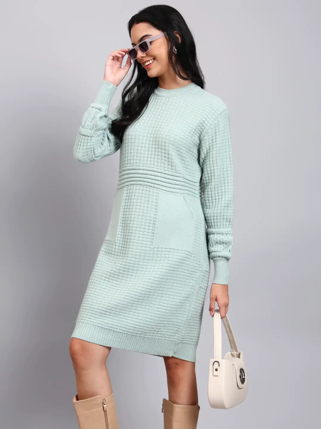 Woman in pistachio green textured knit midi winter dress with round neck, long sleeves, and front pocket. Woman in pistachio green textured knit midi winter dress with round neck, long sleeves, and front pocket.