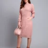 Woman in peach textured knit midi winter dress with long sleeves, round neck, and front pocket.