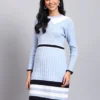 Woman in sky blue ribbed knit winter dress with white scalloped collar, navy border, and long sleeves