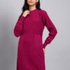 Woman in maroon knit winter dress with pink and white patterned hem, button front, and long sleeves