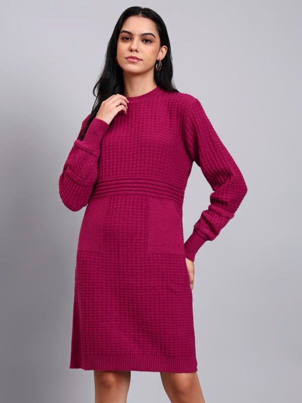 Woman in maroon knit winter dress with pink and white patterned hem, button front, and long sleeves