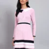Woman in pink ribbed knit winter dress with navy and white scalloped collar, border stripes, and long sleeves
