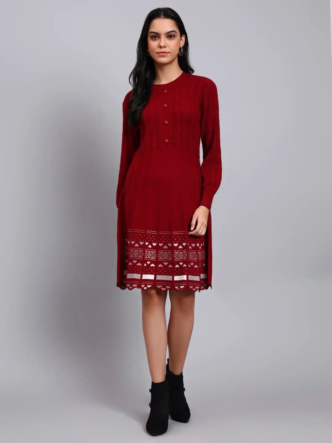 Woman in maroon knit winter dress with pink and white patterned hem, button front, and long sleeves Woman in maroon knit winter dress with pink and white patterned hem, button front, and long sleeves