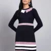 Woman in navy ribbed knit winter dress with pink scalloped collar, colorblock border, and long sleeves