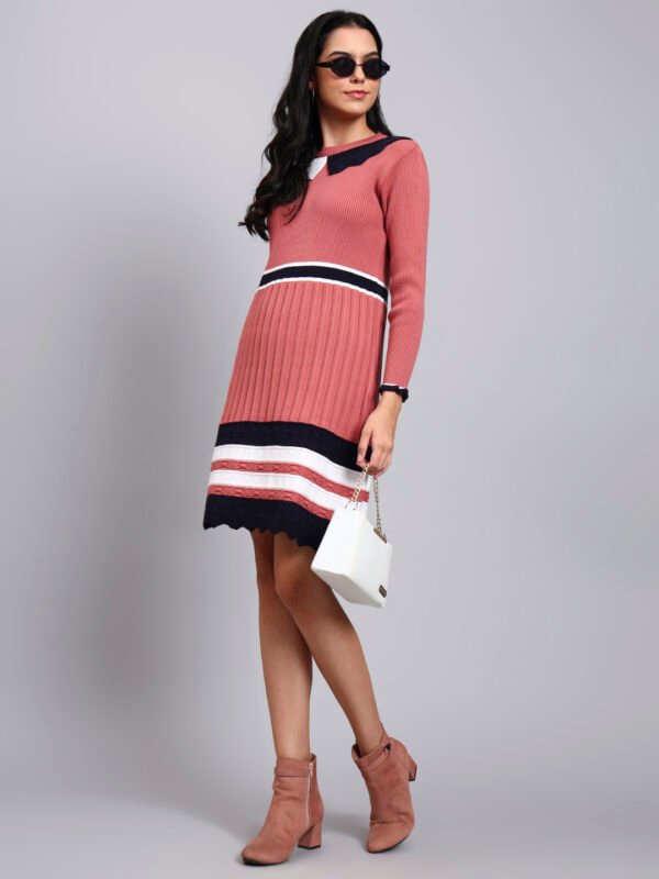 Woman in onion pink ribbed knit winter dress with navy scalloped collar, colorblock border, and long sleeves Woman in onion pink ribbed knit winter dress with navy scalloped collar, colorblock border, and long sleeves