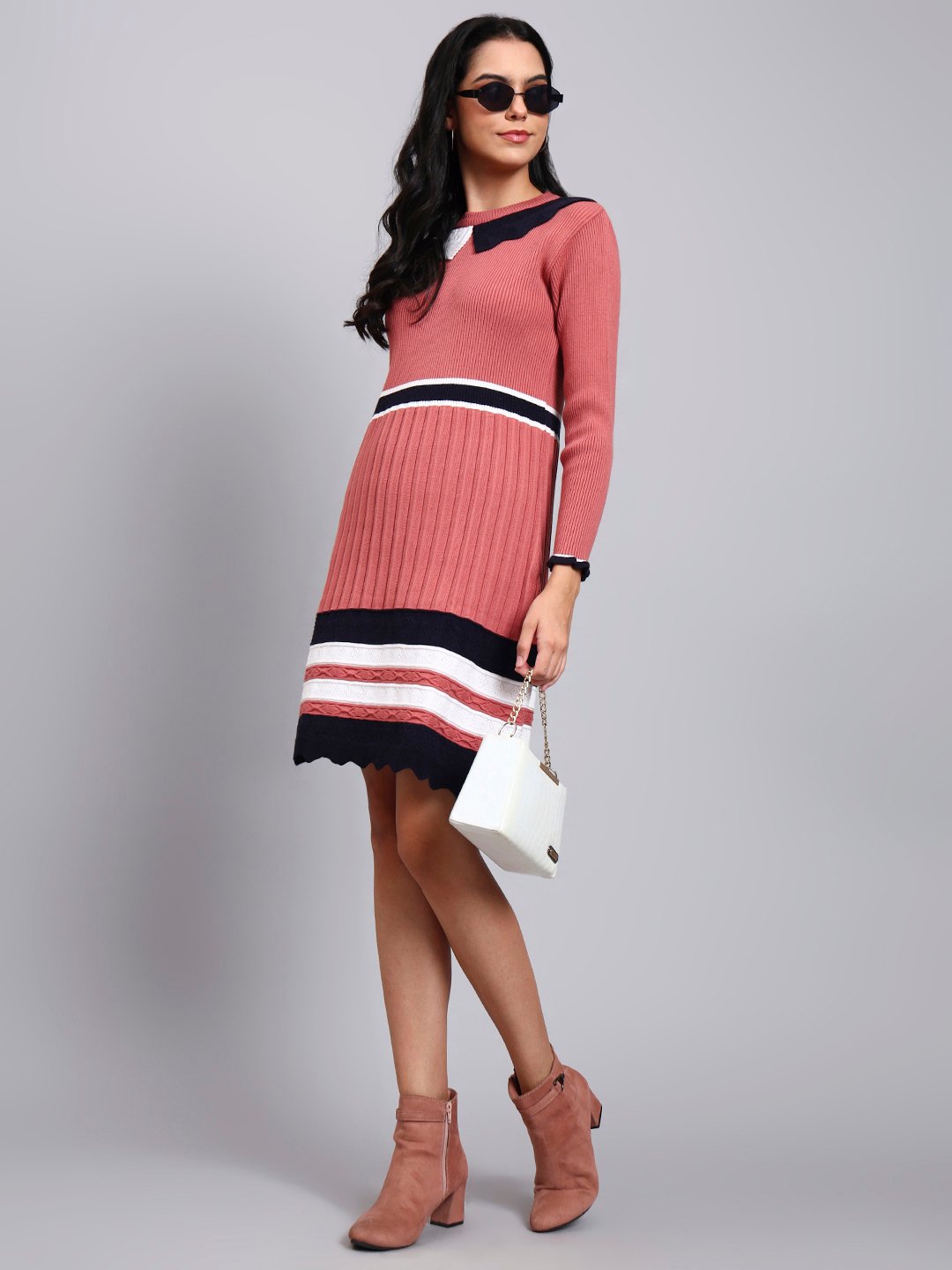 Woman in onion pink ribbed knit winter dress with navy scalloped collar, colorblock border, and long sleeves